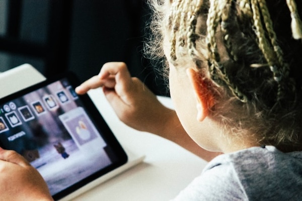 child playing with a tablet