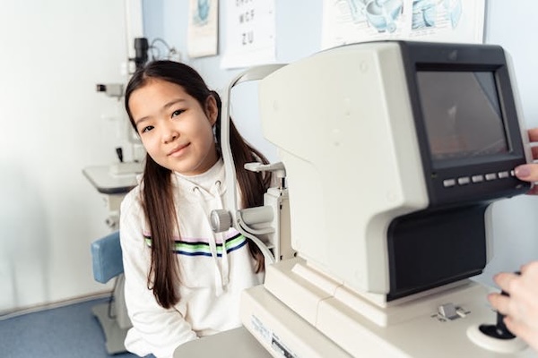 smiling young girl has an eye exam