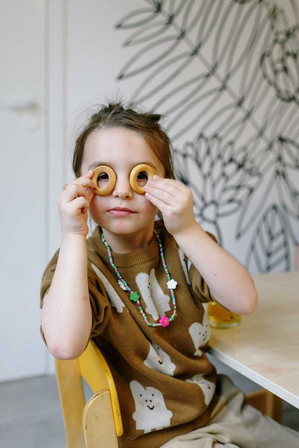 child who puts circles over his eyes
