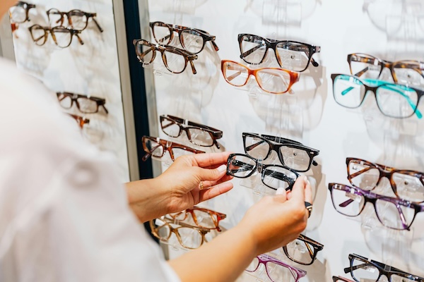 customer selecting a pair of glasses in store