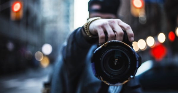 close-up of a photographic lens, in the middle of the city